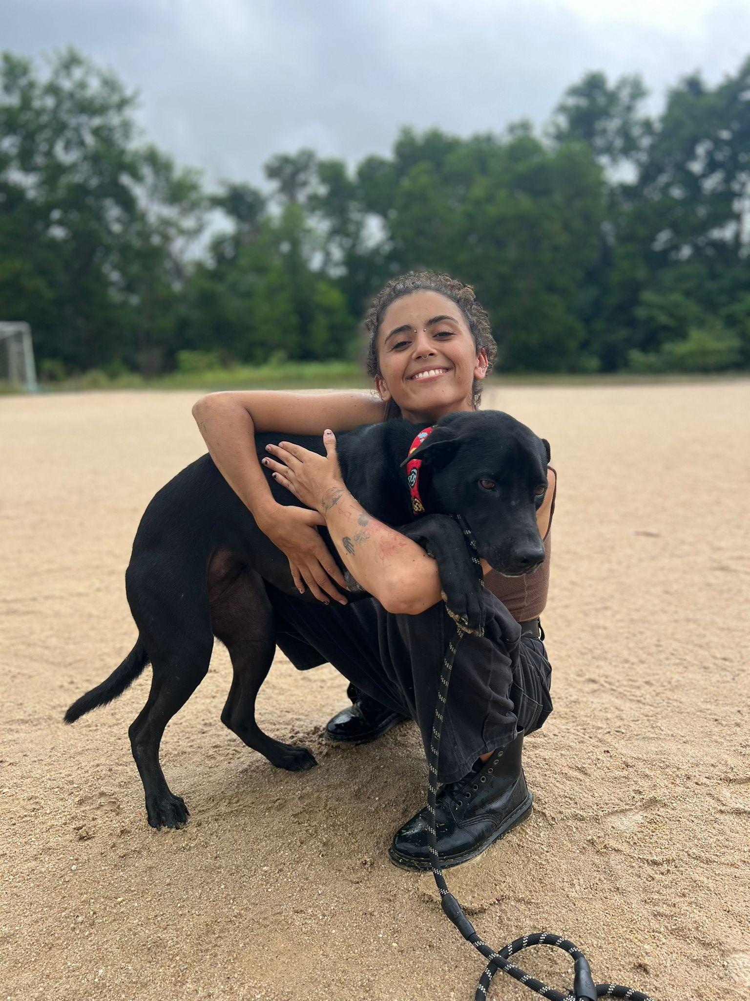 PACS volunteer Noura with Trippy the dog at the clinic